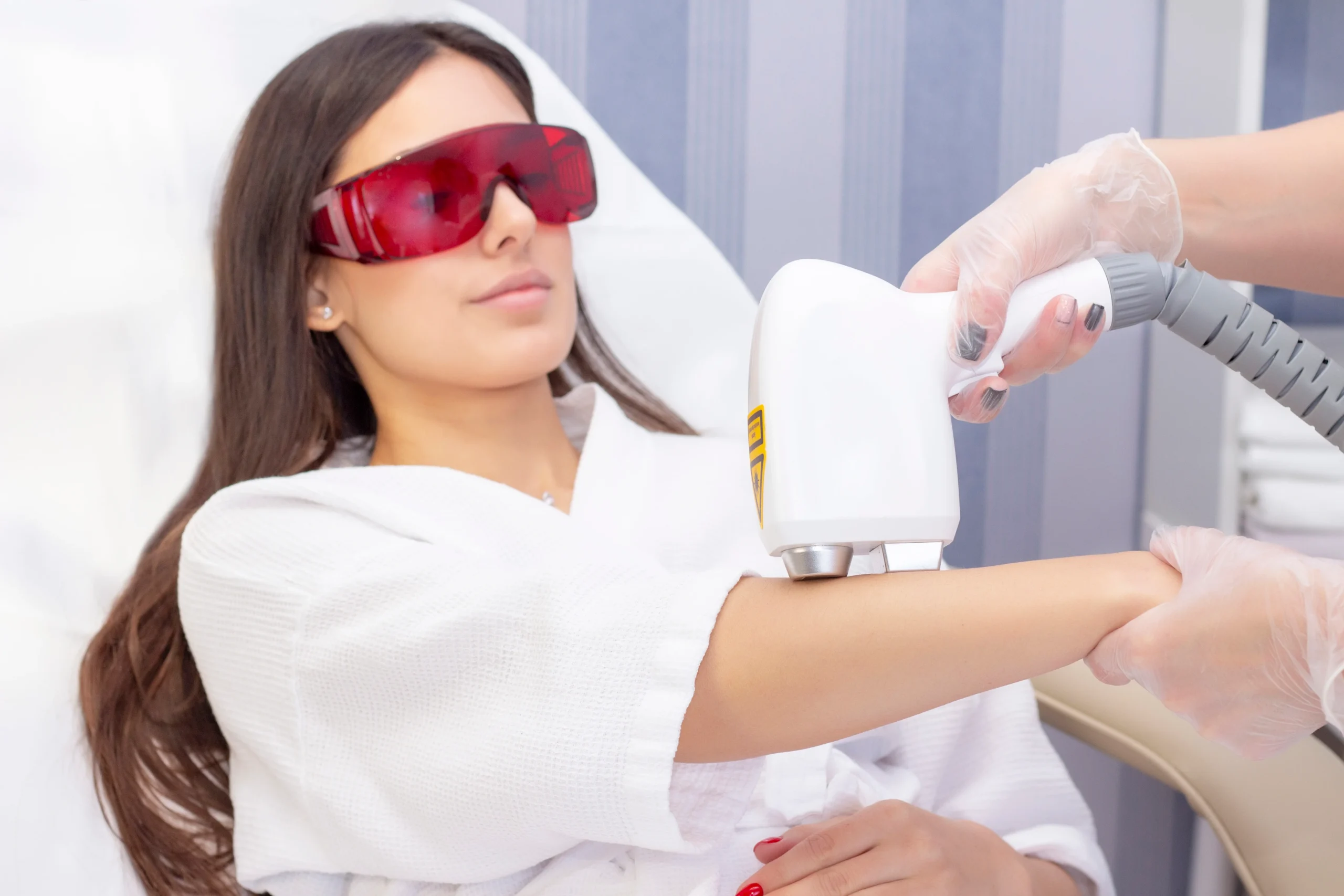 laser-hair-removal-cosmetology-woman-removes-hair-her-arm-with-laser-cosmetology-hair-removal-procedure-laser-hair-removal-cosmetology-cosmetology-spa-concept